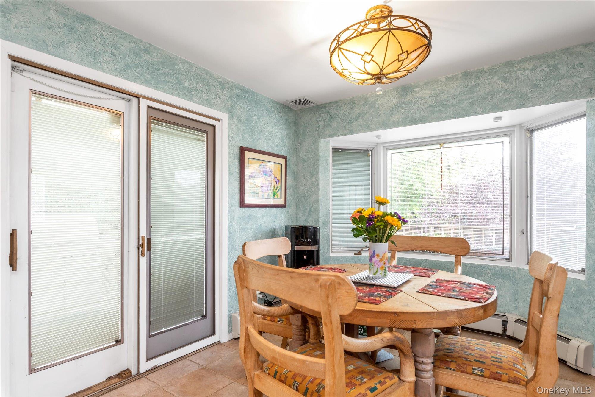 1055 Cedarhurst Street Valley Stream, NY 11581 - Photo 9 of 27 a view of a dining room with furniture window and outside view