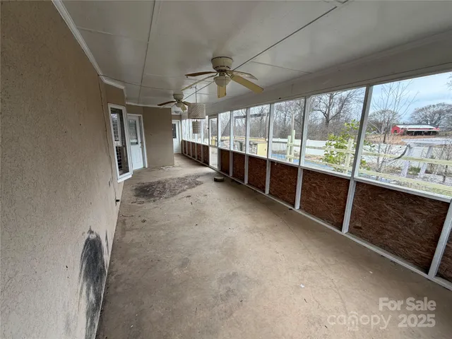 a view of a balcony with wooden floor and fence
