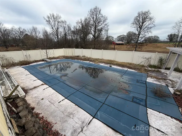 a view of a balcony with floor to ceiling windows and wooden fence