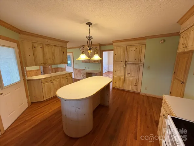a room with wooden floors and sink