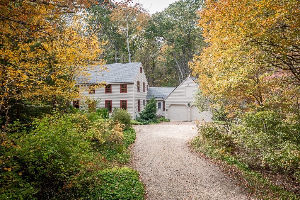 10 Hidden Ledge Road Manchester, MA 01944 - Photo 1 of 40 a aerial view of a house with a yard and large trees