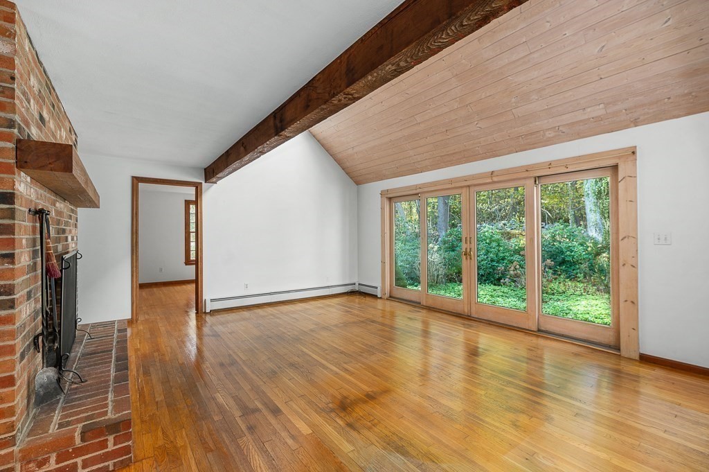 10 Hidden Ledge Road Manchester, MA 01944 - Photo 12 of 40 a view of an empty room with wooden floor and a window