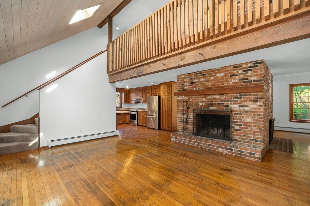 10 Hidden Ledge Road Manchester, MA 01944 - Photo 13 of 40 a view of an empty room with wooden floor fireplace and a window