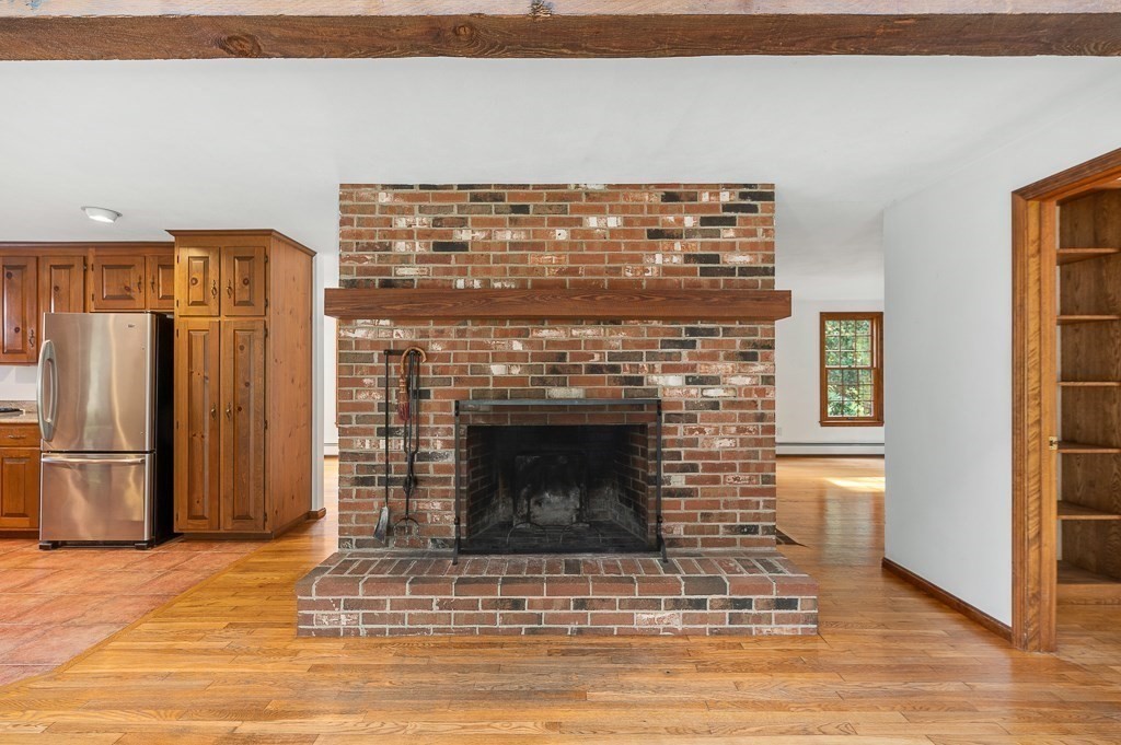 10 Hidden Ledge Road Manchester, MA 01944 - Photo 14 of 40 a living room with a fireplace in it