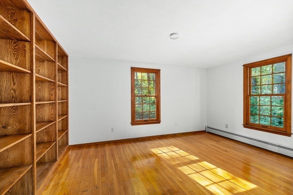 10 Hidden Ledge Road Manchester, MA 01944 - Photo 15 of 40 a view of an empty room with a window and wooden floor