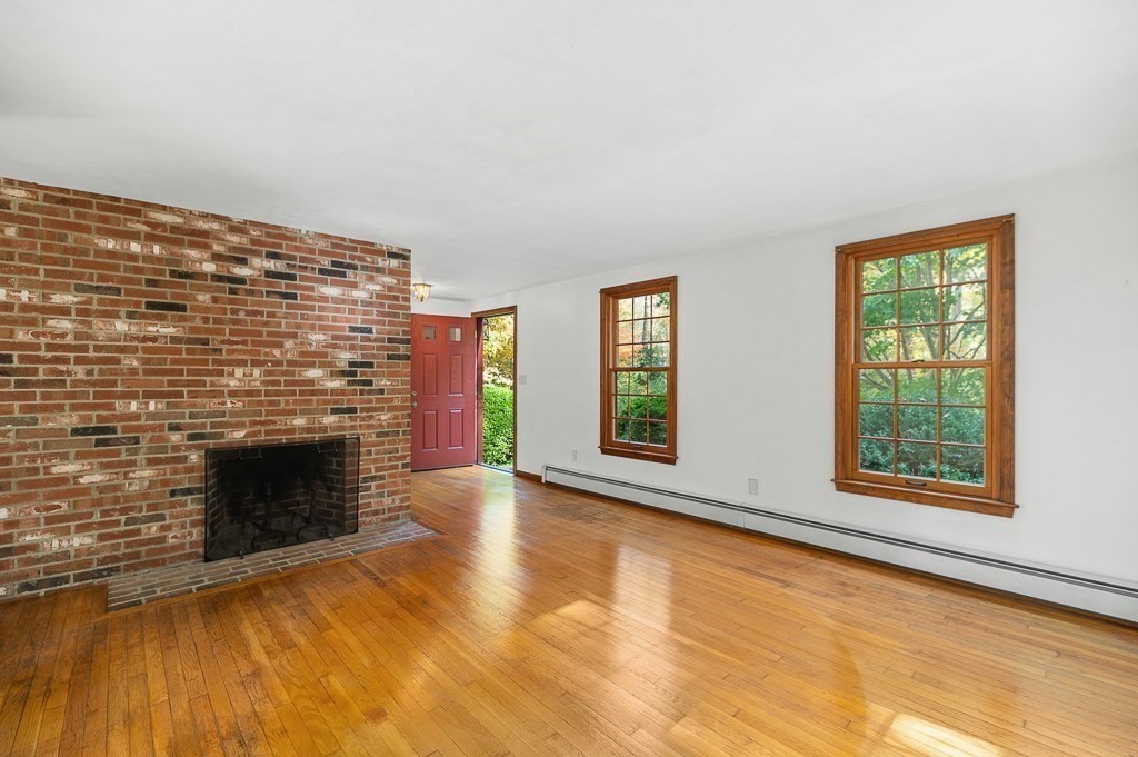 10 Hidden Ledge Road Manchester, MA 01944 - Photo 17 of 40 an empty room with windows and fireplace
