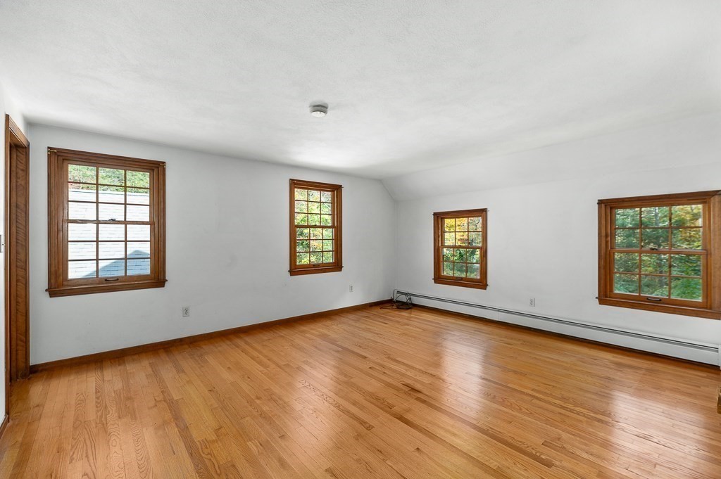 10 Hidden Ledge Road Manchester, MA 01944 - Photo 21 of 40 an empty room with wooden floor and windows