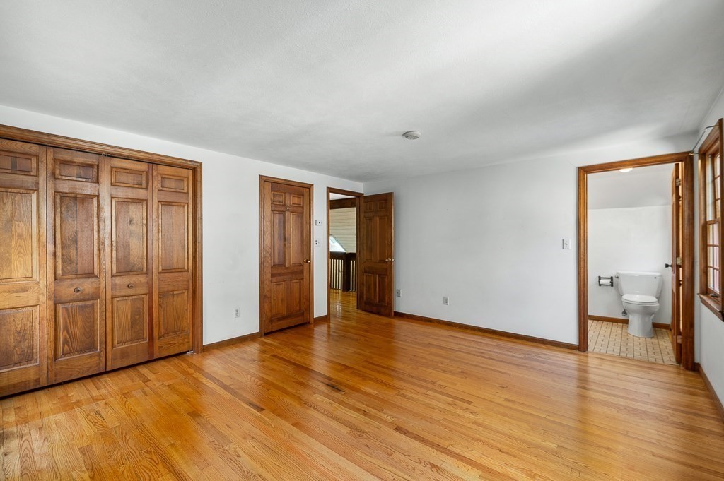 10 Hidden Ledge Road Manchester, MA 01944 - Photo 22 of 40 a view of an empty room with wooden floor and a window