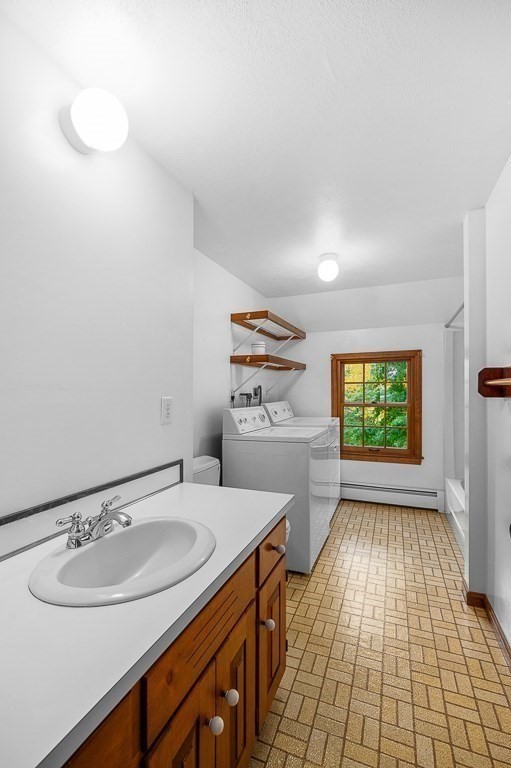 10 Hidden Ledge Road Manchester, MA 01944 - Photo 24 of 40 a bathroom with a sink a toilet and a window