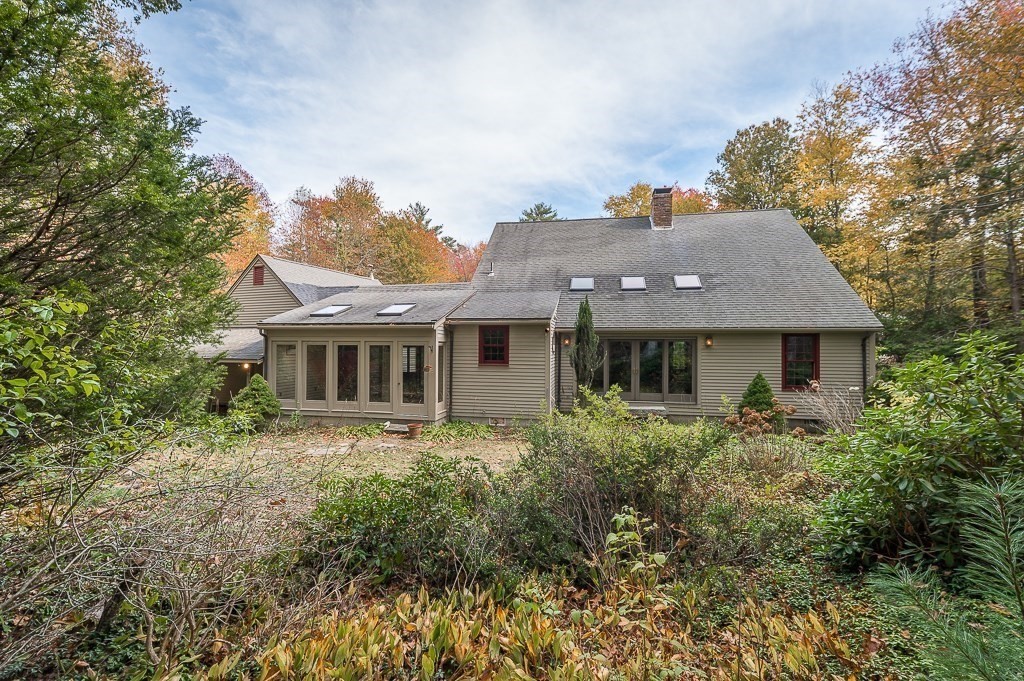 10 Hidden Ledge Road Manchester, MA 01944 - Photo 32 of 40 a front view of house with yard and trees around