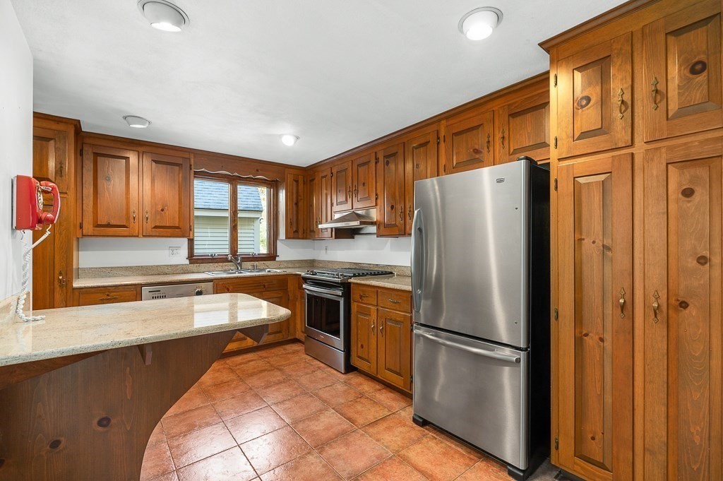 10 Hidden Ledge Road Manchester, MA 01944 - Photo 9 of 40 a kitchen with stainless steel appliances granite countertop a refrigerator and a sink