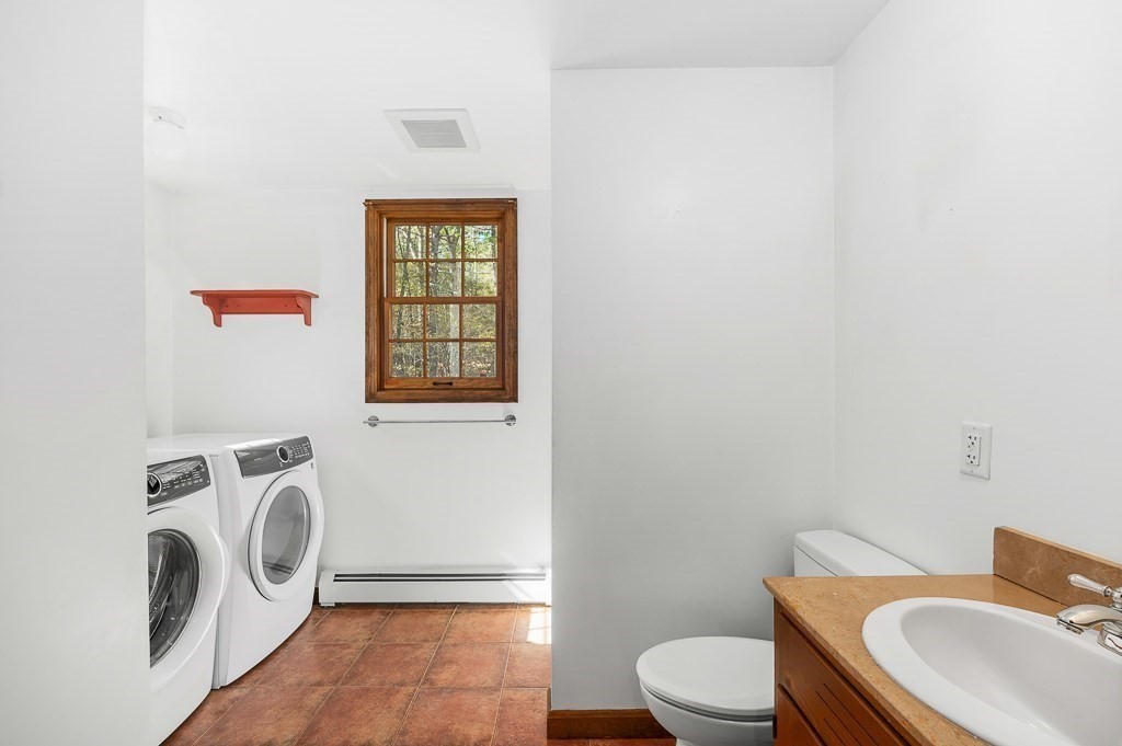 10 Hidden Ledge Road Manchester, MA 01944 - Photo 10 of 40 a bathroom with a toilet a sink and mirror