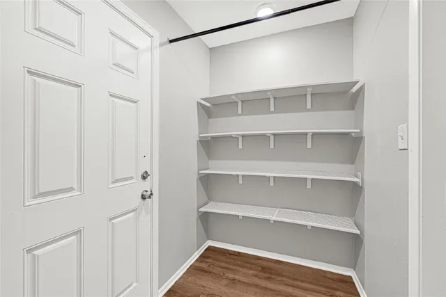 a view of empty room with floor to ceiling windows with walls