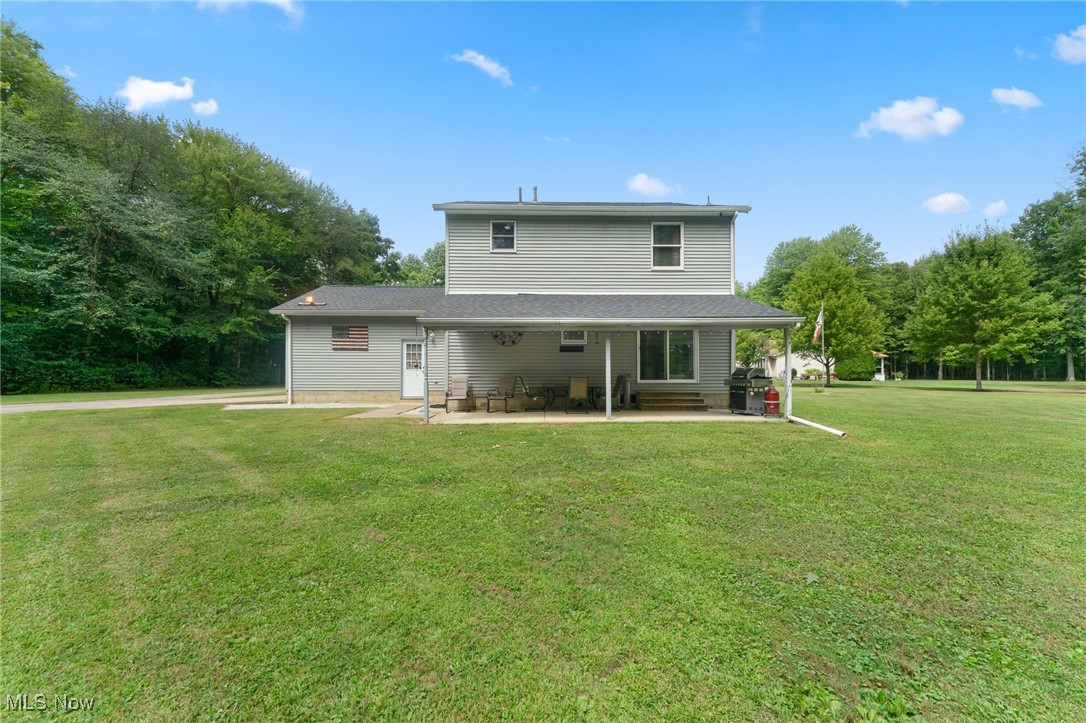 1761 Rustic Run Road Warren, OH 44481 - Photo 11 of 45 Rear view of property featuring a lawn and a patio