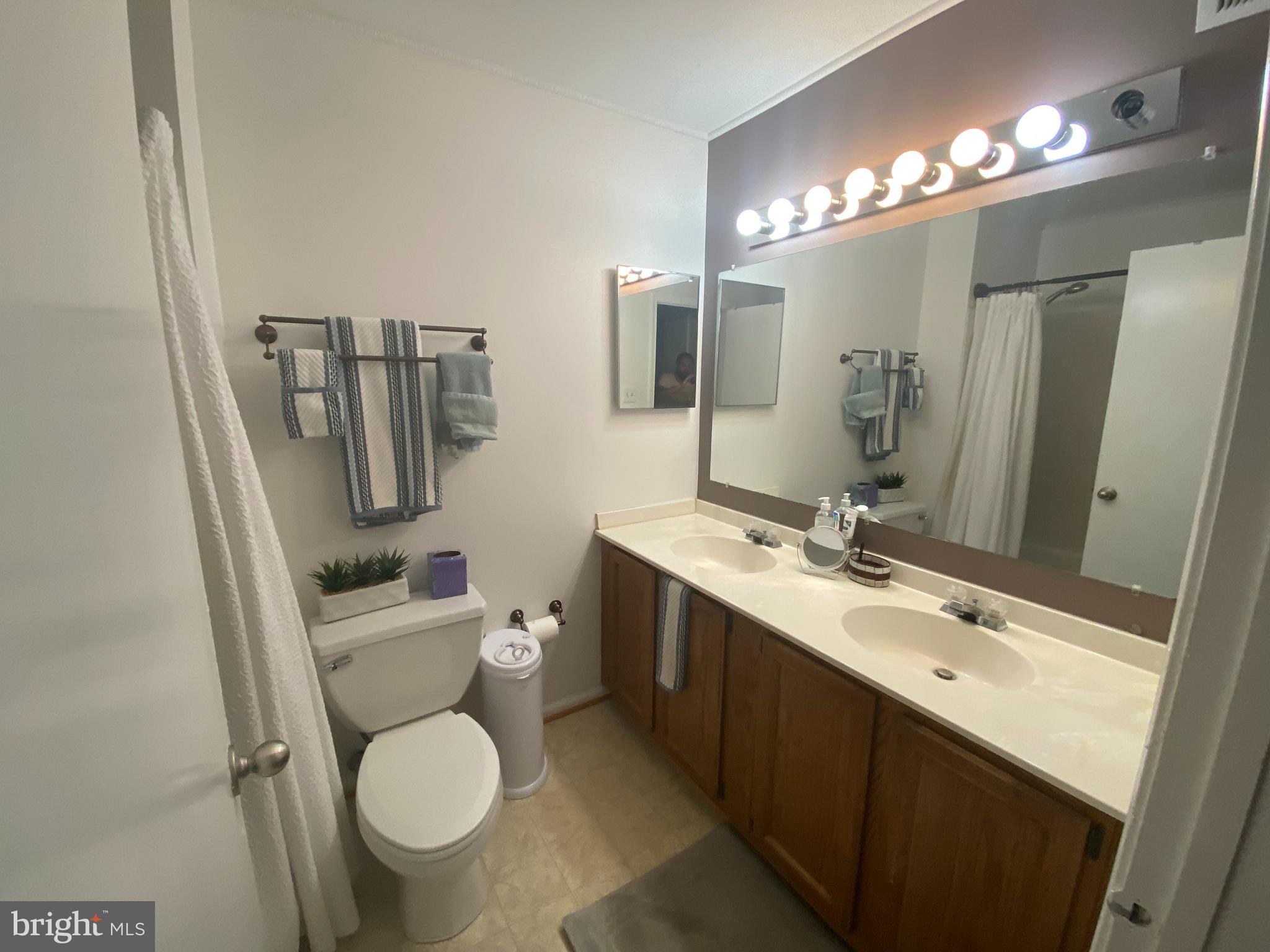 8523 Gambel Oak Drive Springfield, VA 22153 - Photo 19 of 41 a bathroom with a toilet sink and mirror