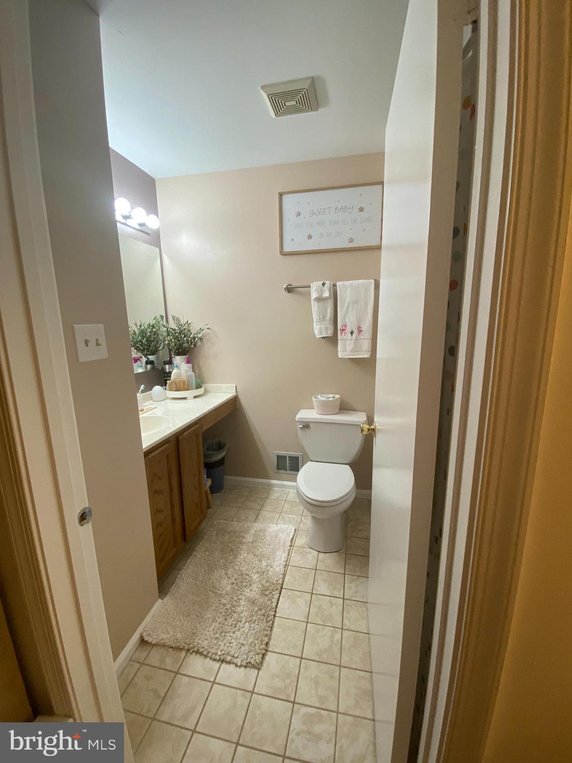 8523 Gambel Oak Drive Springfield, VA 22153 - Photo 28 of 41 a spacious bathroom with a toilet a sink and a mirror