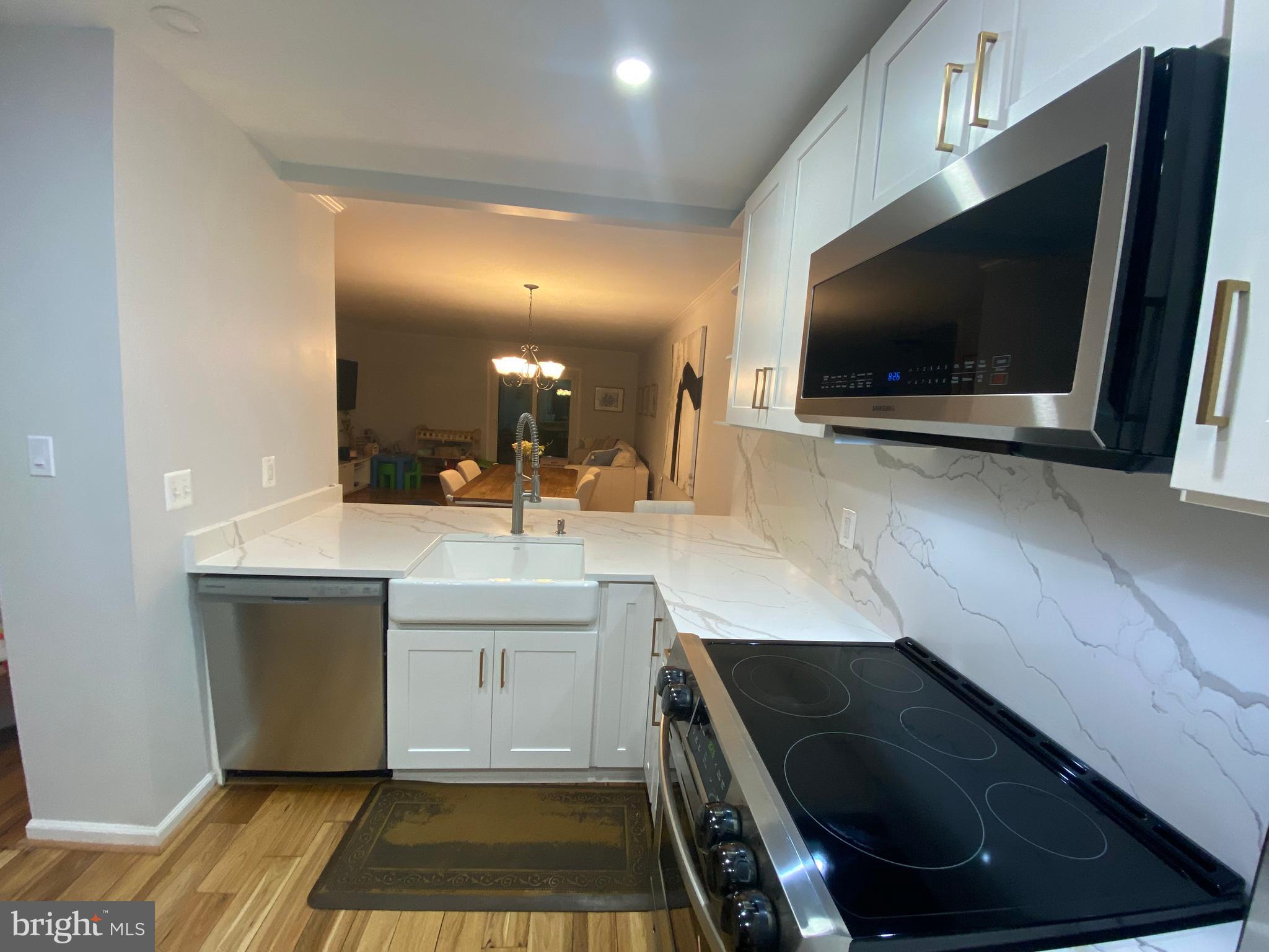 8523 Gambel Oak Drive Springfield, VA 22153 - Photo 33 of 41 a kitchen with a sink and a stove top oven