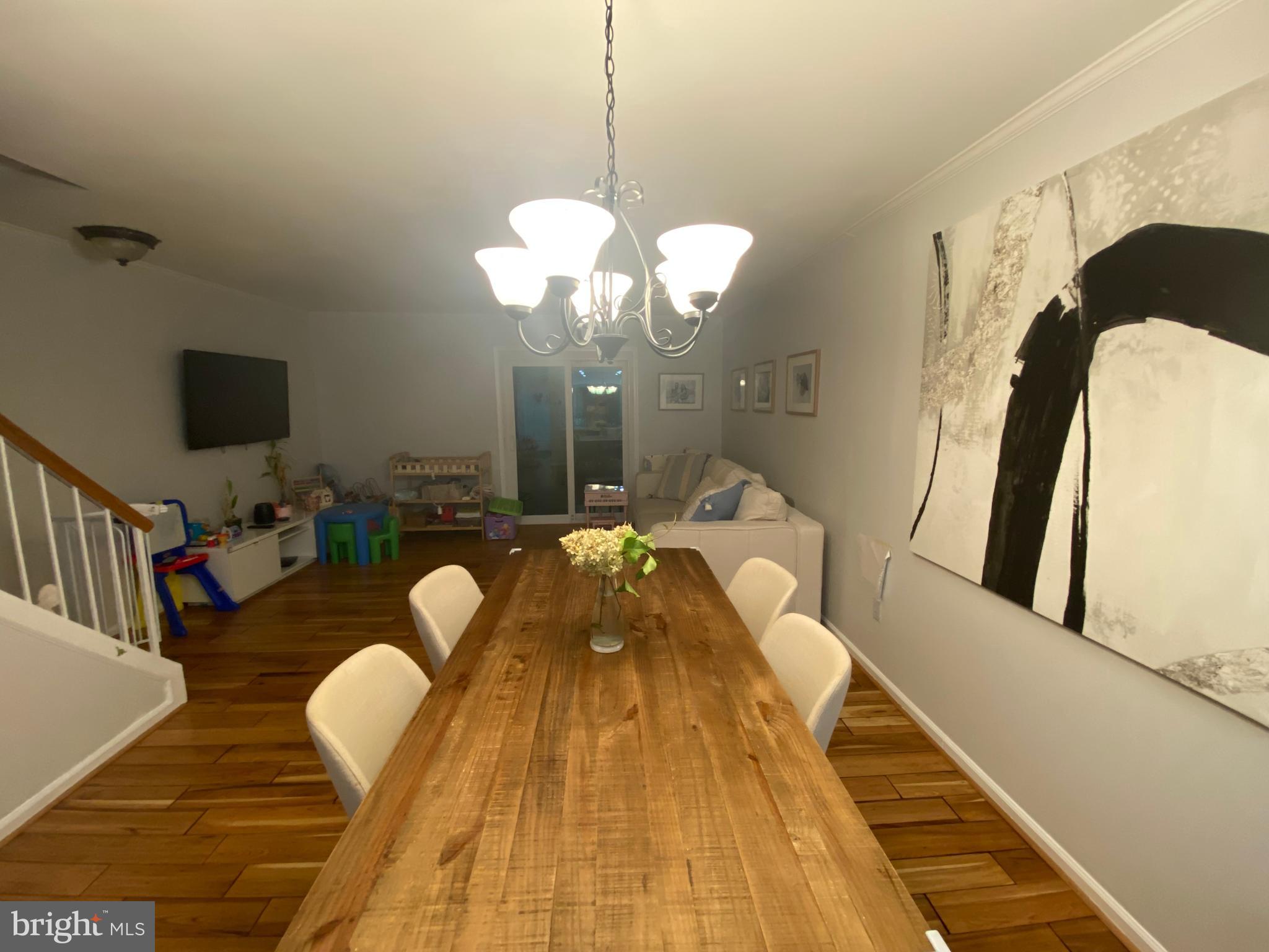 8523 Gambel Oak Drive Springfield, VA 22153 - Photo 35 of 41 a living room with furniture dining table and a chandelier