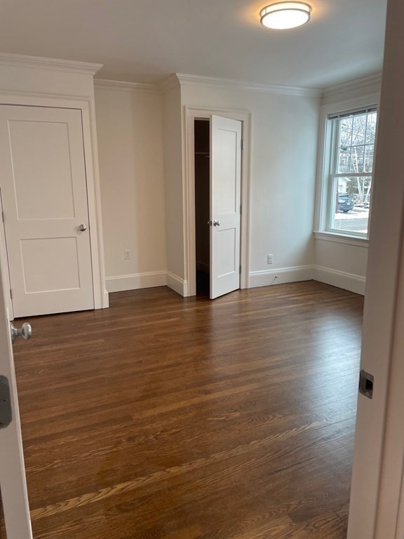 55 Dalton Road, Unit 1 Belmont, MA 02478 - Photo 13 of 16 a view of an empty room with wooden floor and a window