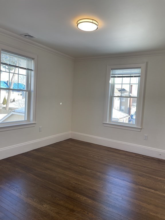 55 Dalton Road, Unit 1 Belmont, MA 02478 - Photo 14 of 16 an empty room with wooden floor and windows