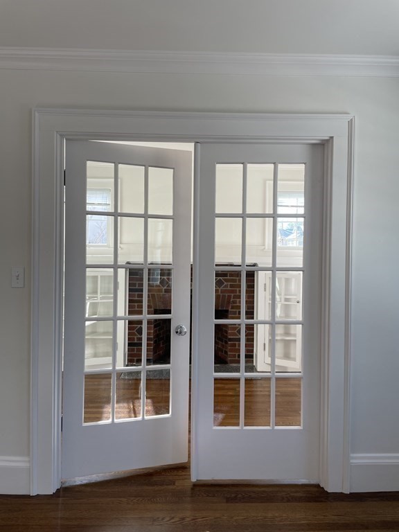 55 Dalton Road, Unit 1 Belmont, MA 02478 - Photo 6 of 16 a view of empty room with wooden floor and windows
