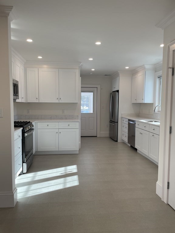 55 Dalton Road, Unit 1 Belmont, MA 02478 - Photo 8 of 16 a kitchen with stainless steel appliances granite countertop a refrigerator sink and cabinets