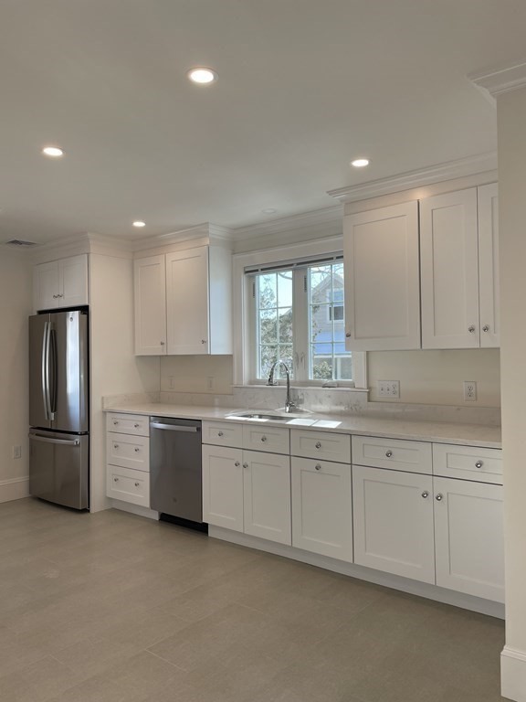 55 Dalton Road, Unit 1 Belmont, MA 02478 - Photo 9 of 16 a large kitchen with stainless steel appliances granite countertop a stove a sink and a refrigerator