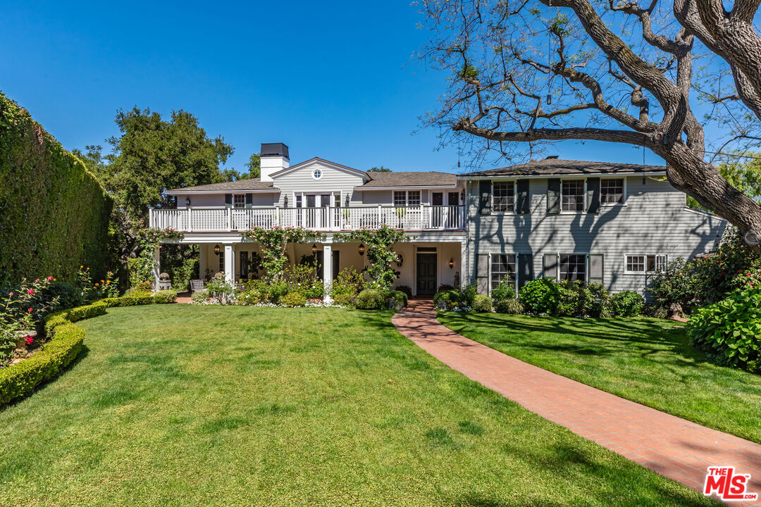 685 Elkins Road Los Angeles, CA 90049 - Photo 1 of 24 a front view of a house with a yard