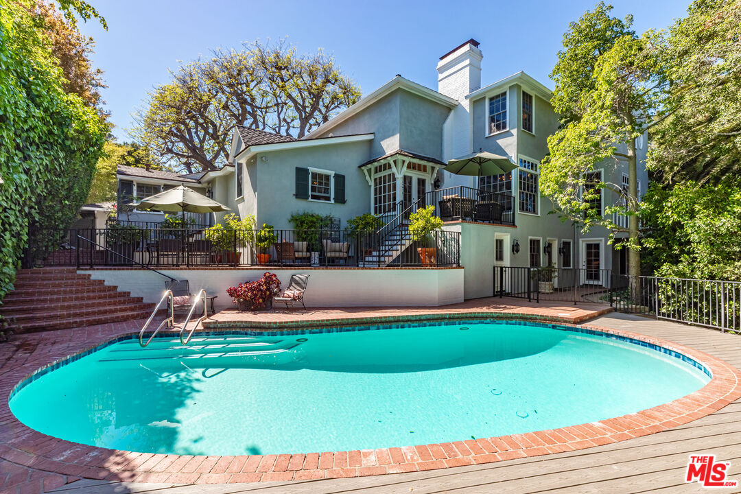 685 Elkins Road Los Angeles, CA 90049 - Photo 18 of 24 a front view of a house with swimming pool having outdoor seating