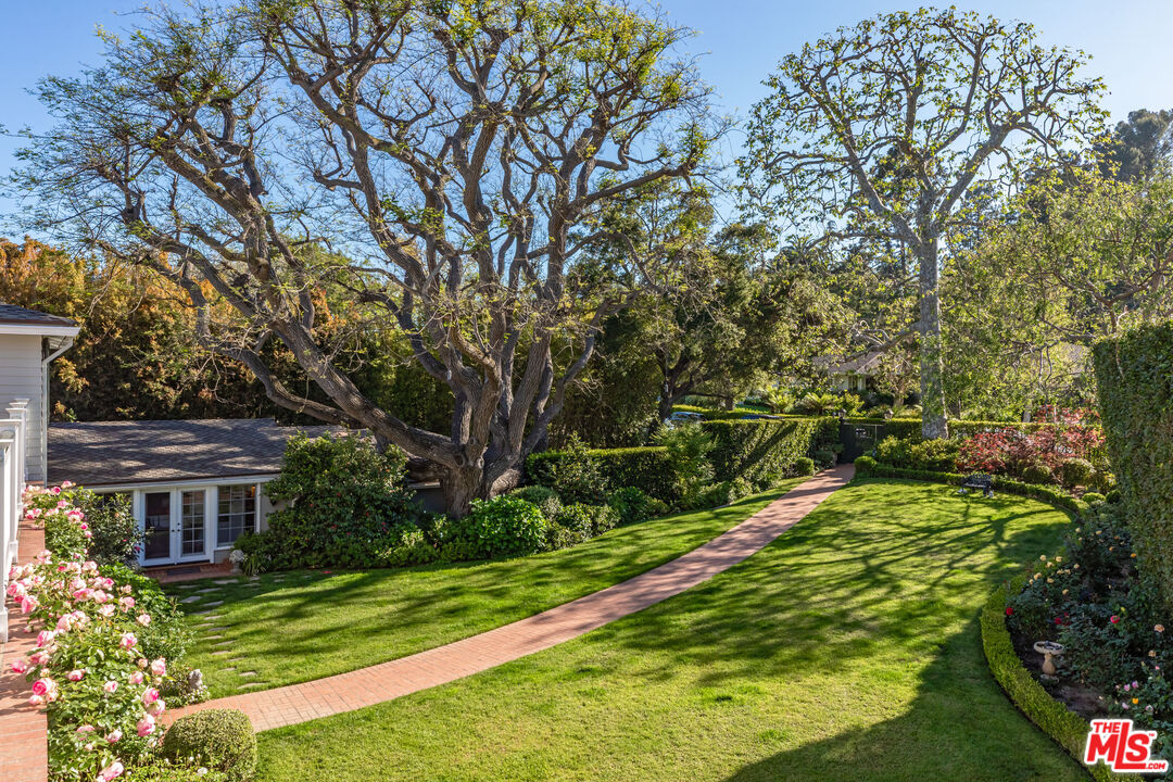 685 Elkins Road Los Angeles, CA 90049 - Photo 2 of 24 a view of a house with a yard