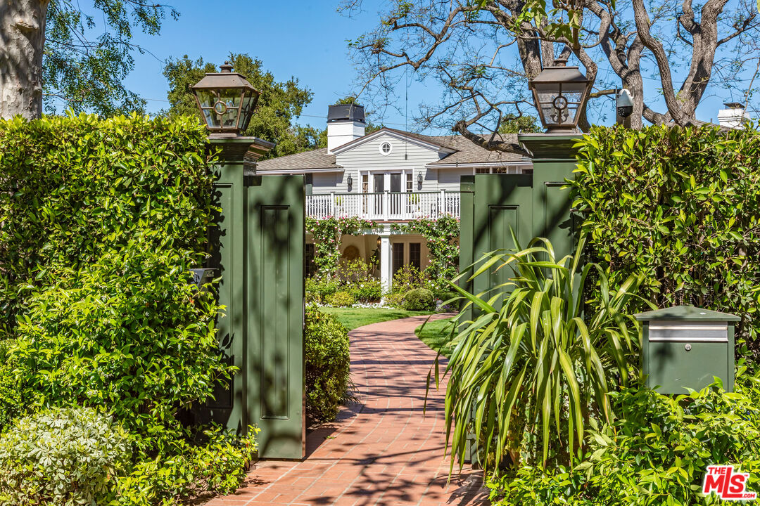 685 Elkins Road Los Angeles, CA 90049 - Photo 22 of 24 a front view of a house with a garden