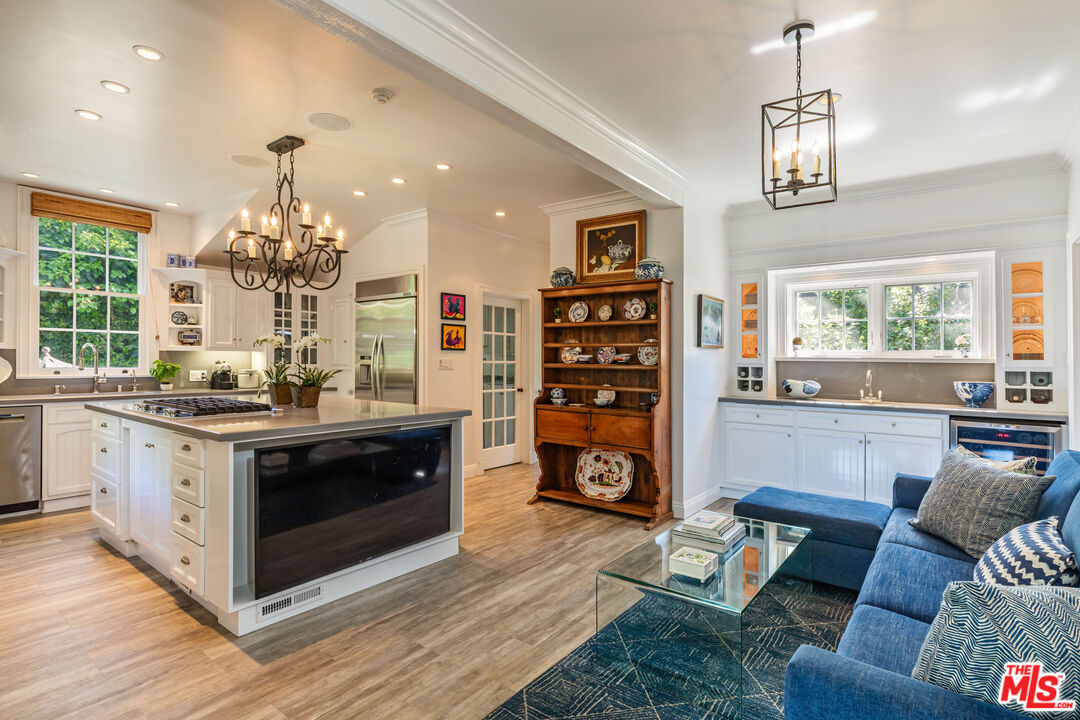 685 Elkins Road Los Angeles, CA 90049 - Photo 7 of 24 a living room with furniture and a chandelier