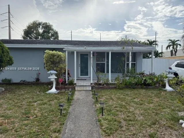 a view of a house with backyard sitting area and garden