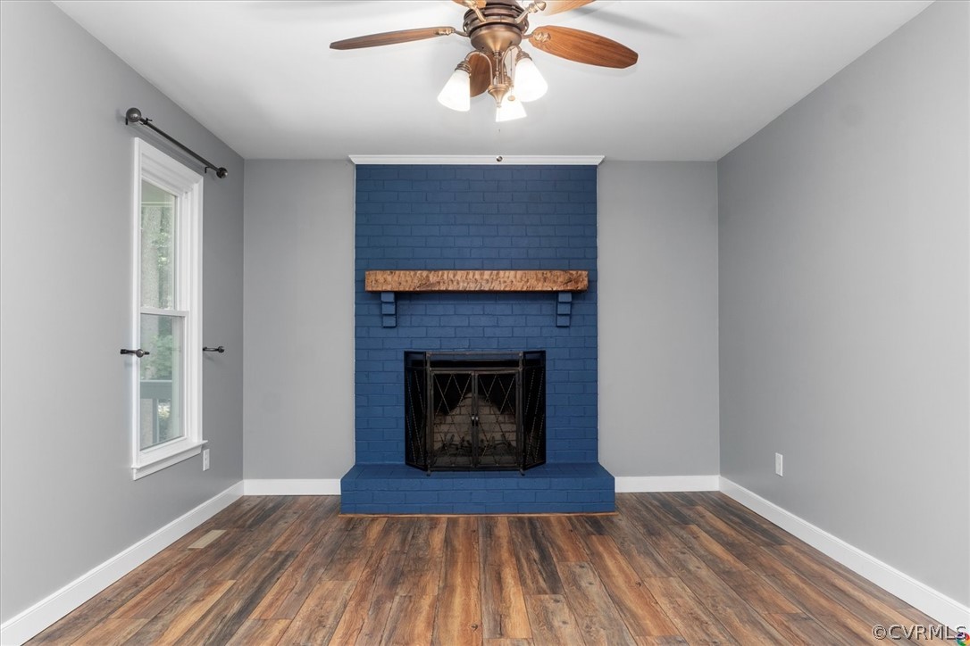 10211 Robbie Road Chesterfield, VA 23832 - Photo 13 of 50 a living room with a fireplace and wooden floor