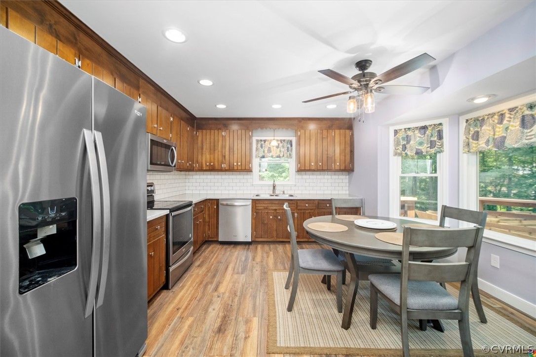 10211 Robbie Road Chesterfield, VA 23832 - Photo 17 of 50 a kitchen with a table chairs refrigerator and microwave