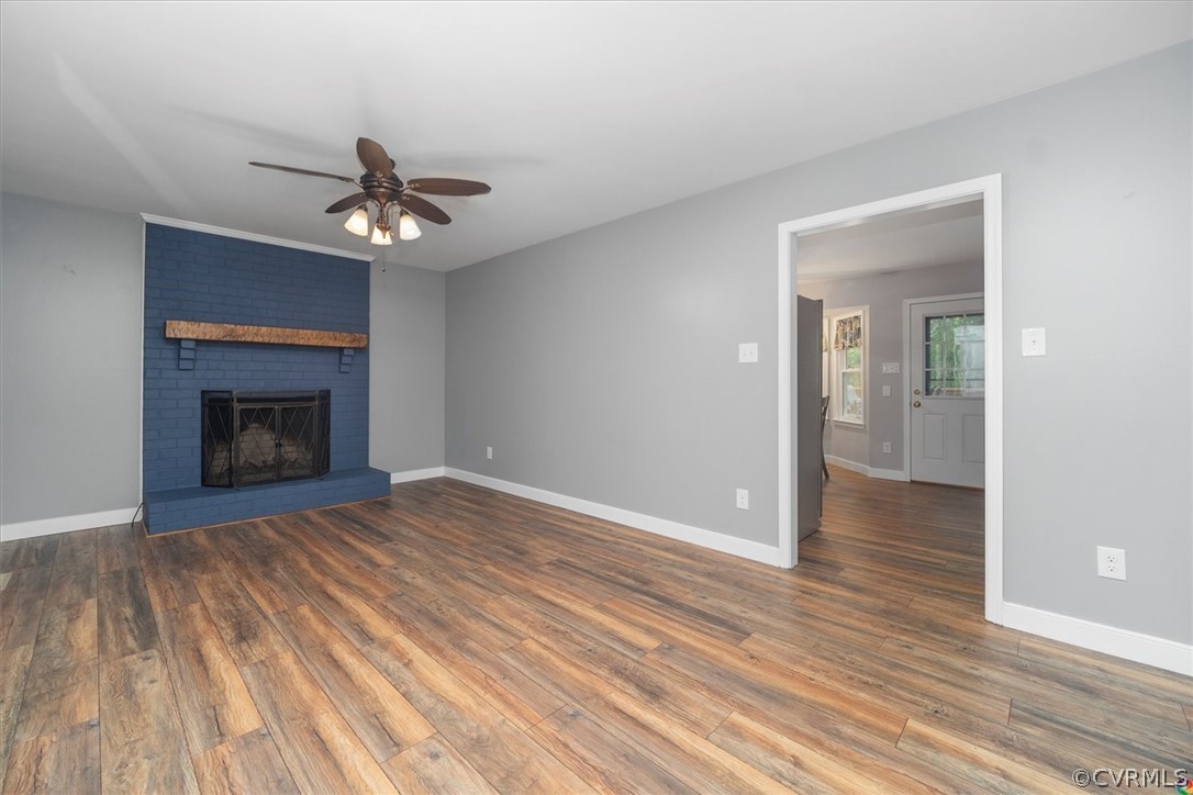 10211 Robbie Road Chesterfield, VA 23832 - Photo 10 of 50 a view of an empty room with wooden floor fireplace and a window