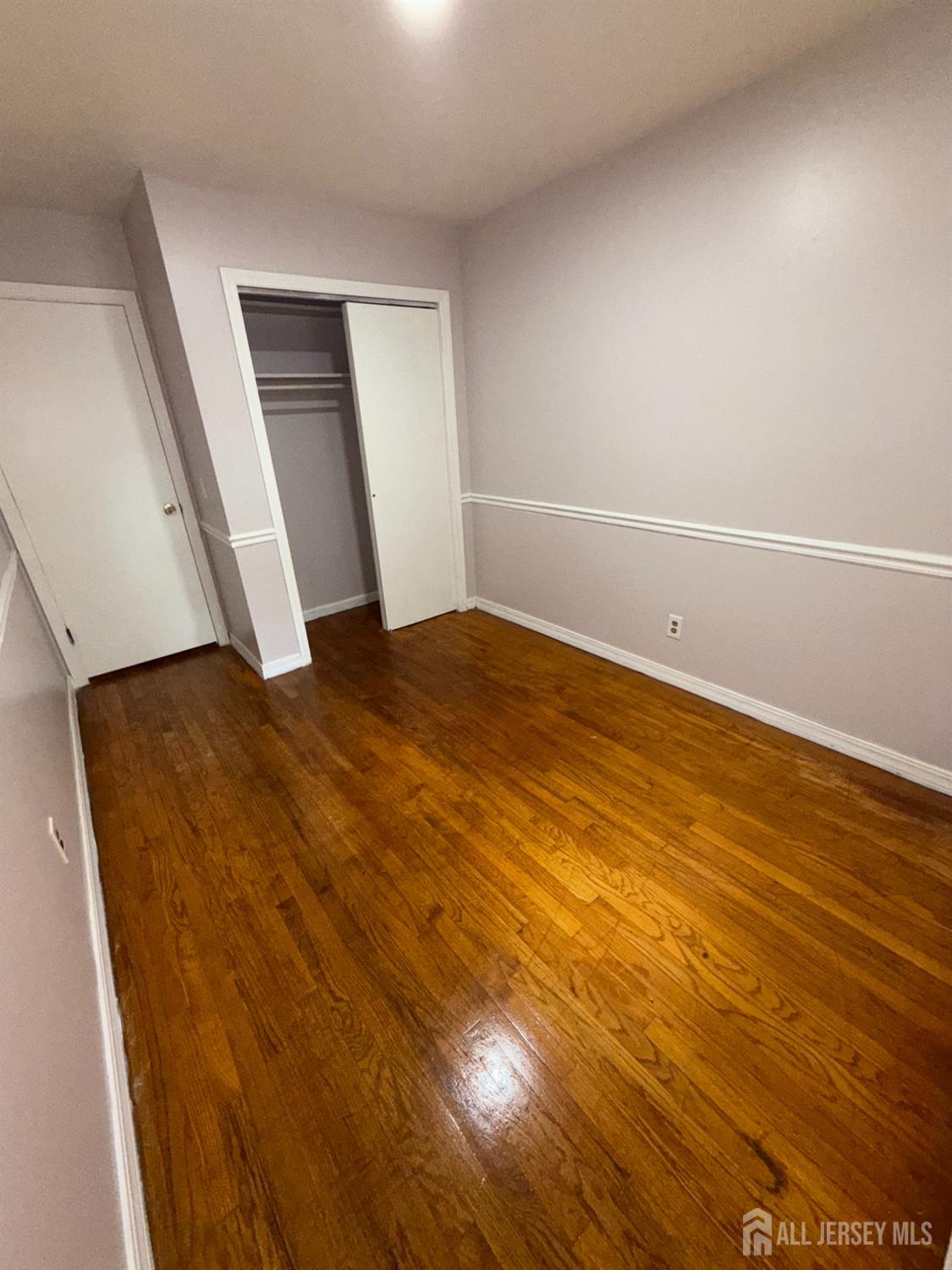 134 Oak Street, Unit 1 Rahway, NJ 07065 - Photo 12 of 16 a view of empty room with wooden floor