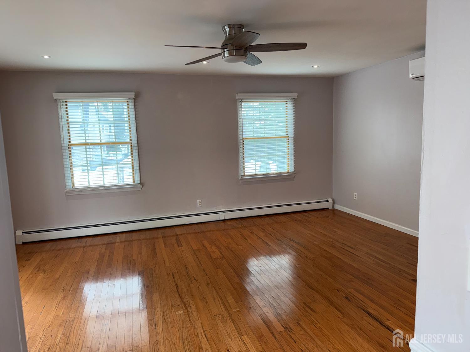 134 Oak Street, Unit 1 Rahway, NJ 07065 - Photo 13 of 16 a view of an empty room with wooden floor and a window