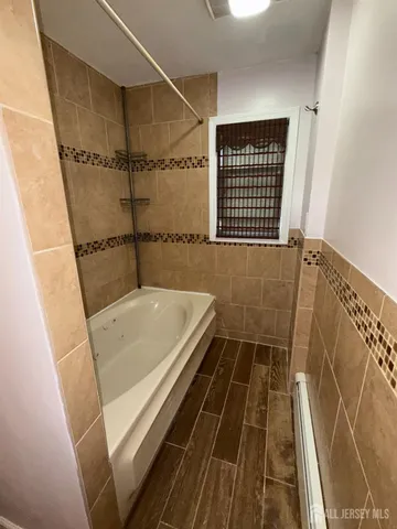 a bathroom with a tub and shower