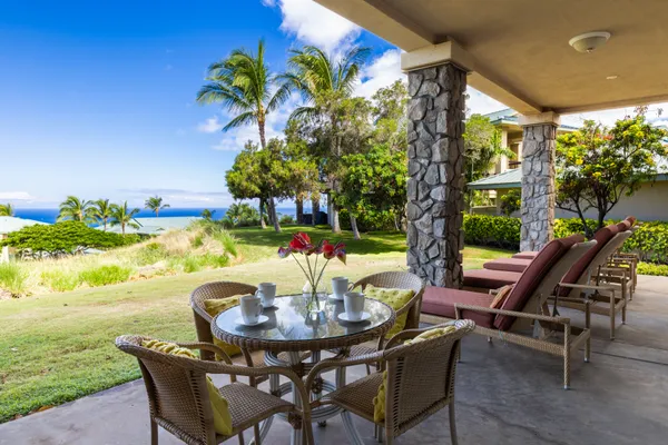 a view of an outdoor dining space with a table and chairs