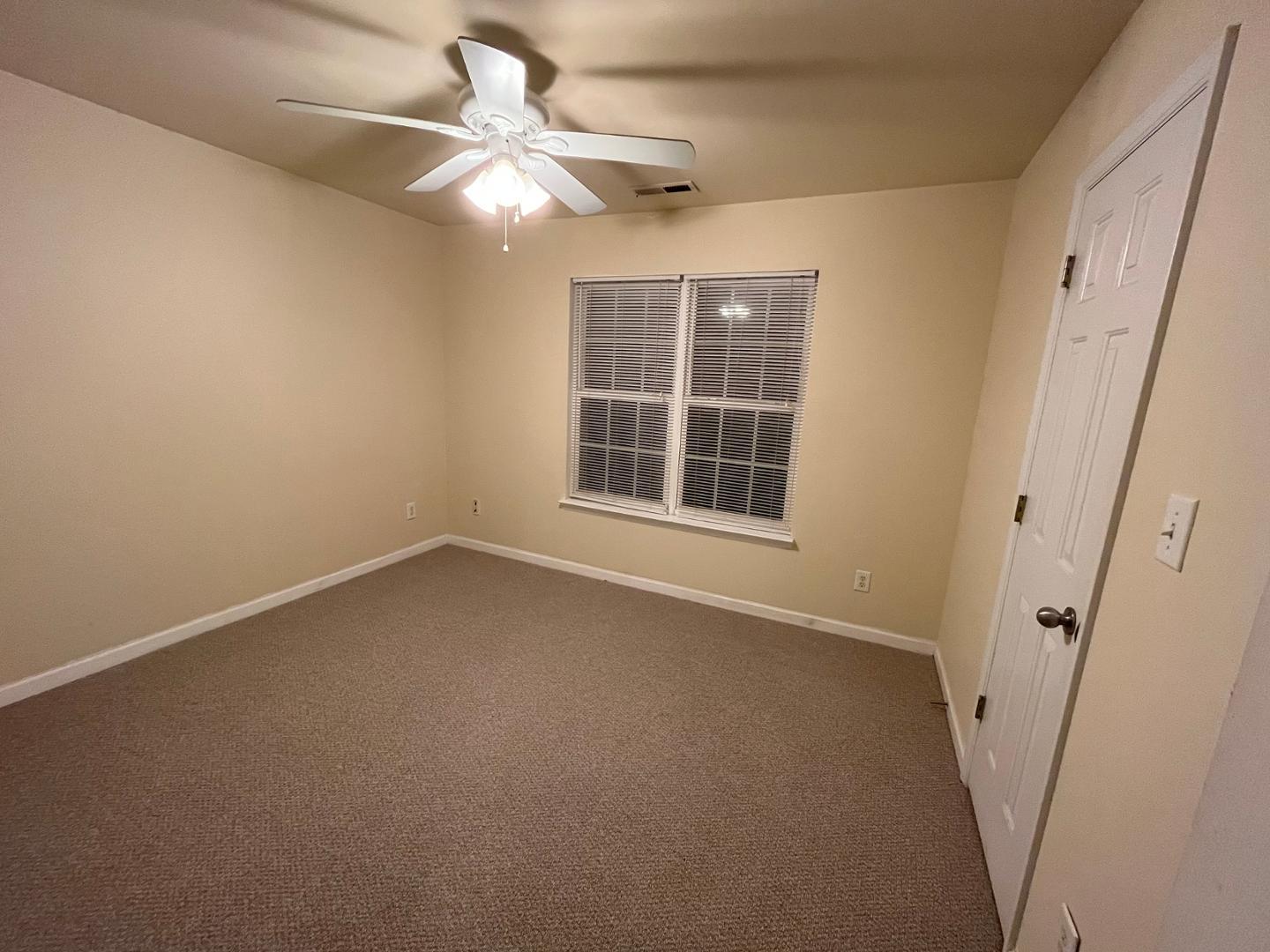 156 Blue Crest Lane Durham, NC 27705 - Photo 12 of 13 an empty room with windows and fan