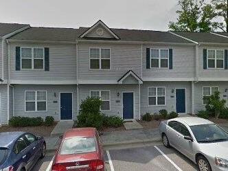 156 Blue Crest Lane Durham, NC 27705 - Photo 2 of 13 a front view of a house with a garden