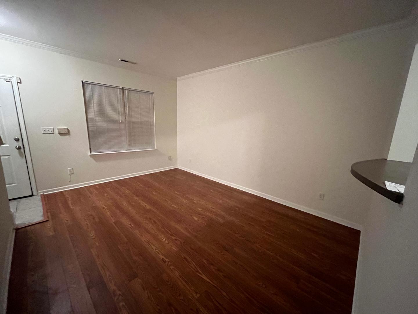 156 Blue Crest Lane Durham, NC 27705 - Photo 4 of 13 an empty room with wooden floor and windows