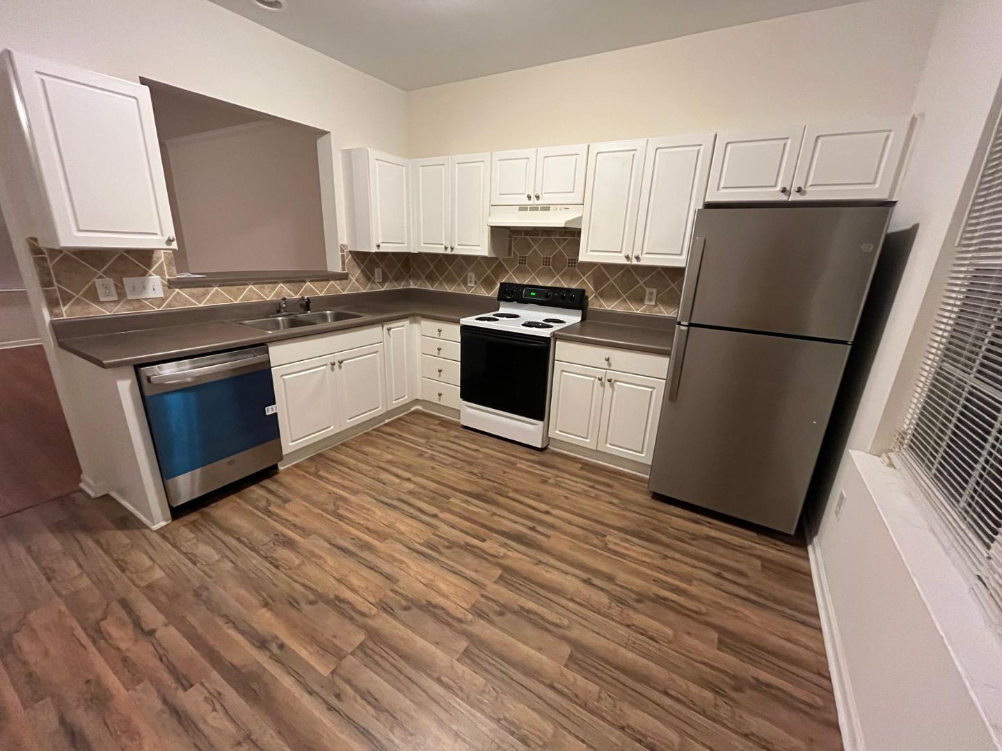 156 Blue Crest Lane Durham, NC 27705 - Photo 6 of 13 a kitchen with granite countertop a refrigerator stove top oven and sink