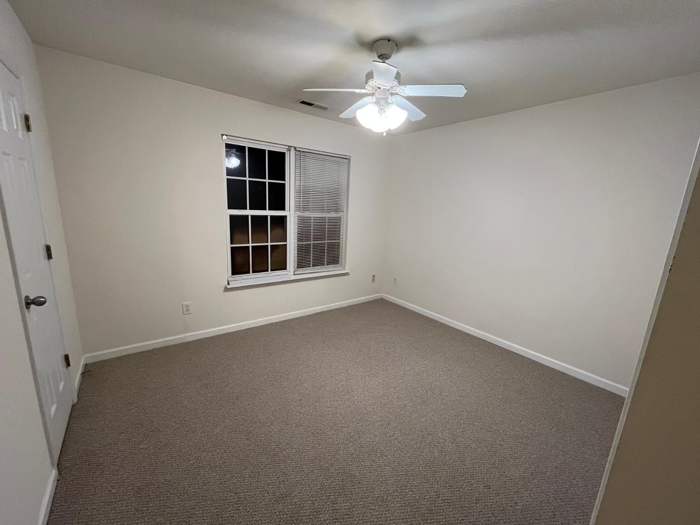 156 Blue Crest Lane Durham, NC 27705 - Photo 10 of 13 en empty room with windows and chandelier fan
