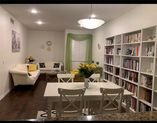 a living room with furniture and a book shelf