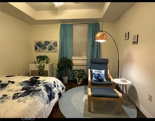 a bedroom with bed and a mirror