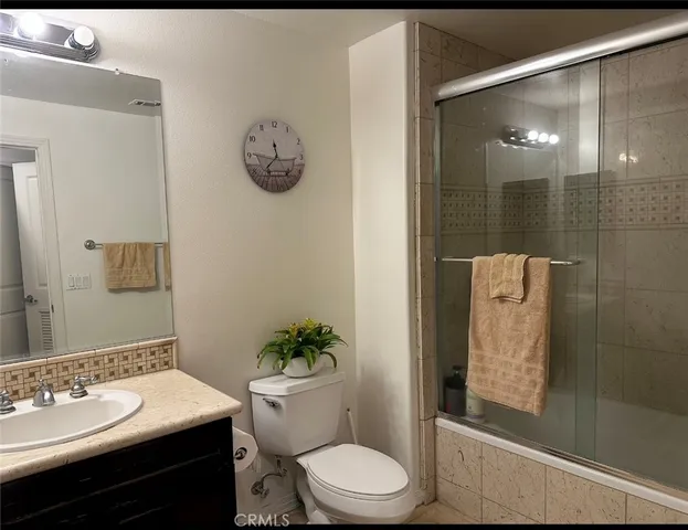 a bathroom with a toilet sink and shower