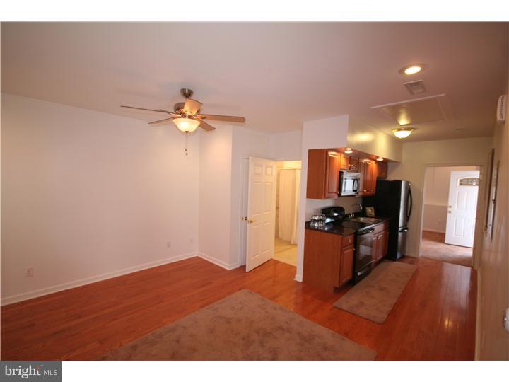 1109 South 23rd Street Philadelphia, PA 19146 - Photo 4 of 4 a view of kitchen with furniture and a chandelier