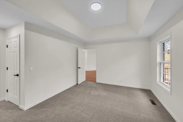 an empty room with windows and closet